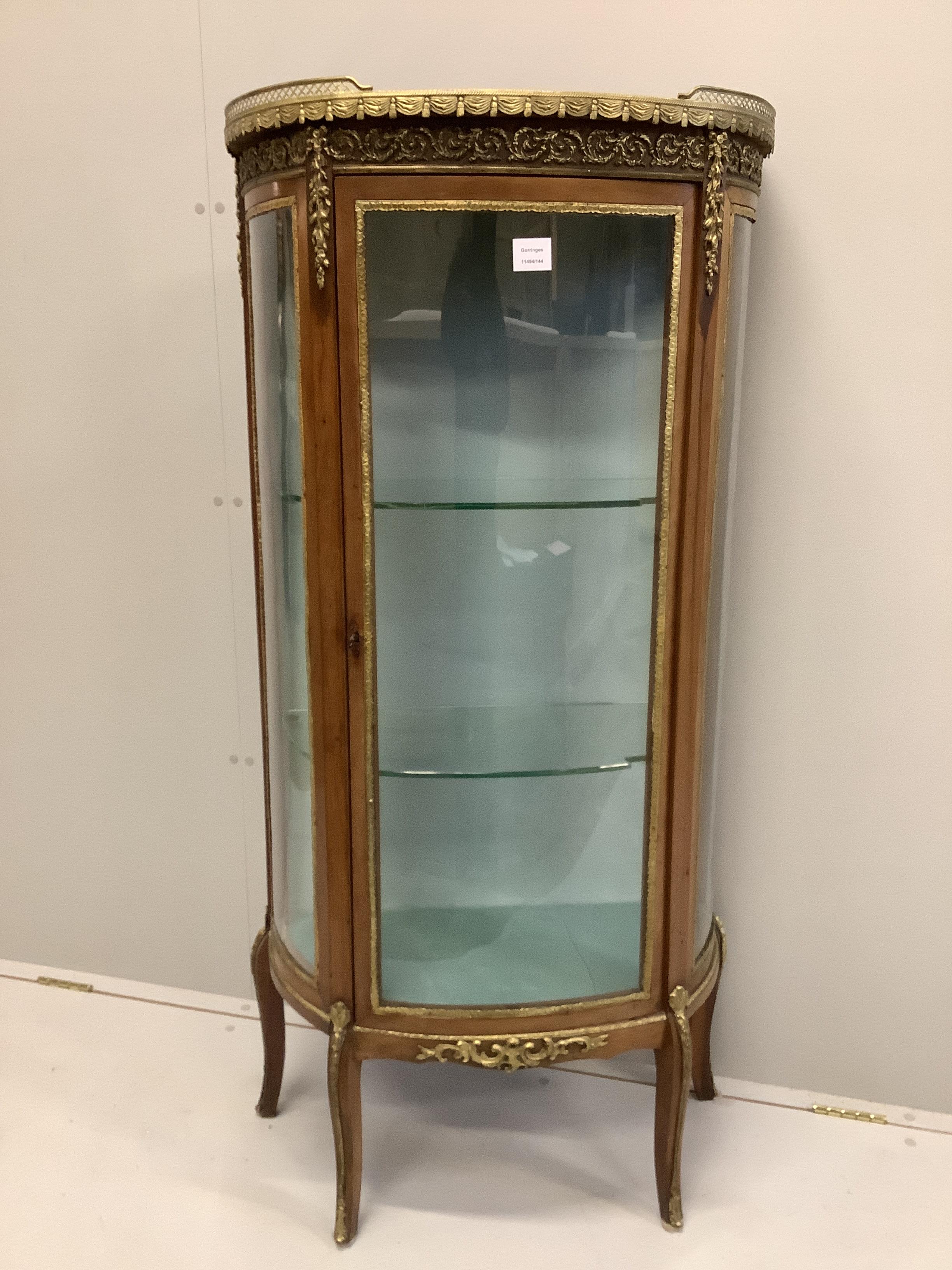A French gilt metal mounted marble topped bow front vitrine, width 66cm, depth 32cm, height 140cm